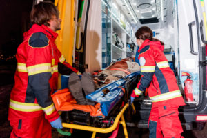 paramedics putting man in ambulance